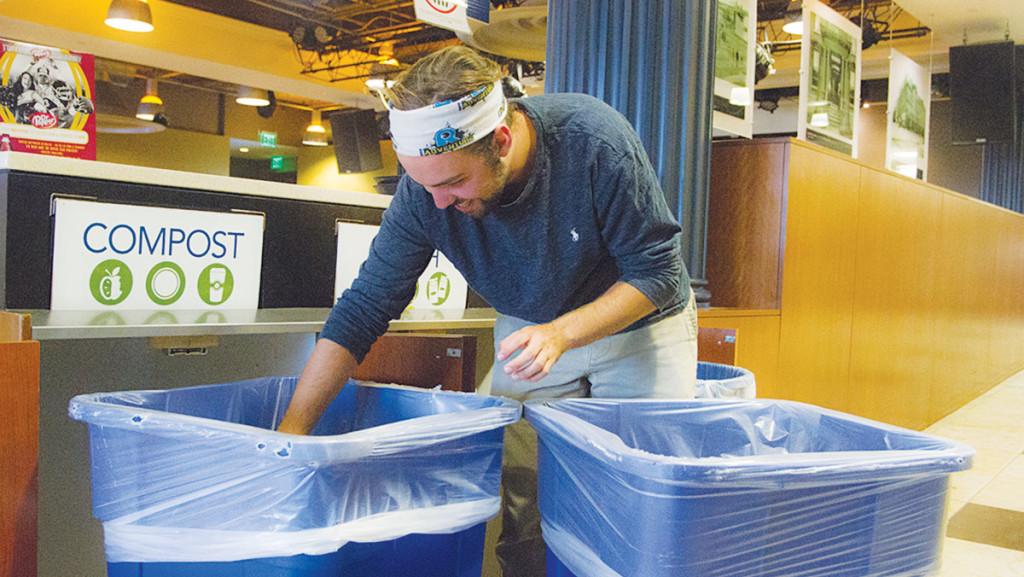 Ben Tolles, sustainability project assistant for the Eco-Reps, sorts through the trash and recycling in IC Square. The Resource and Environmental Management Program is planning to have one Eco-Rep in each residence hall.