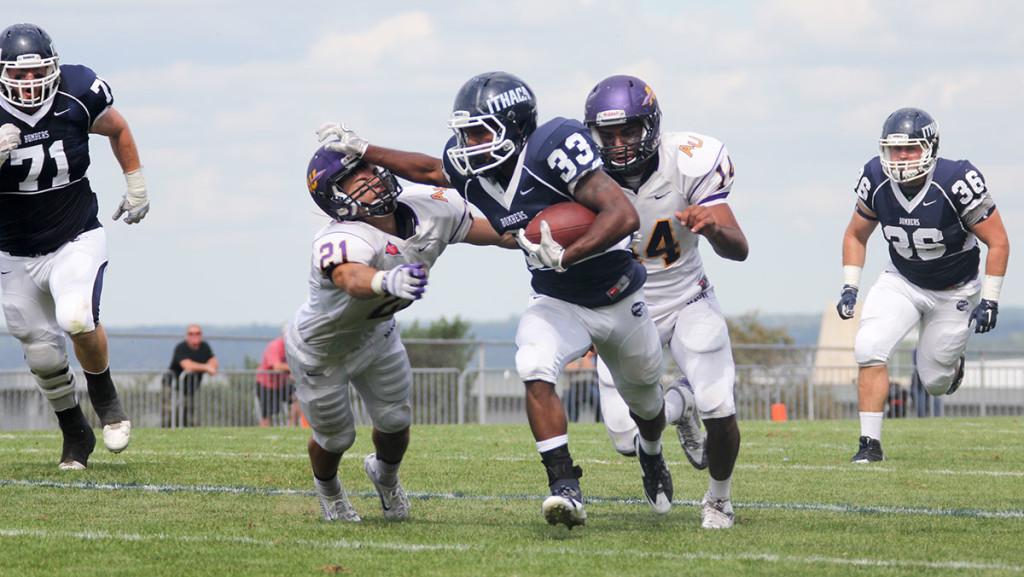 Sophomore running back Tristan Brown stiff arms an Alfred University defender during the football teams 38–18 win over the Saxons on Sept. 26 at Butterfield Stadium. Brown rushed for a season-high 180 yards and scored two touchdowns on the afternoon. 