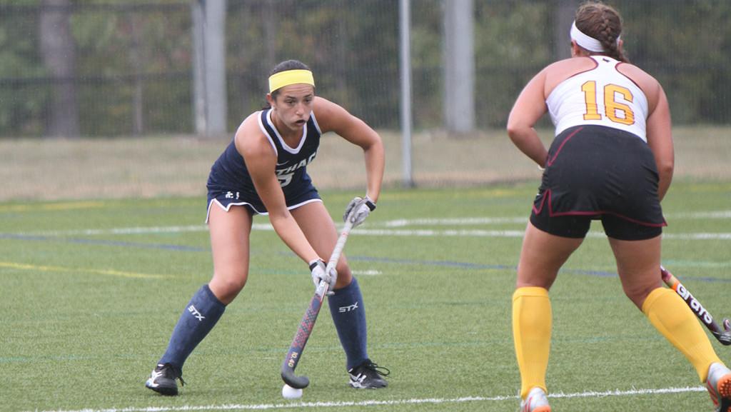 Sophomore Amanda Schell stands off with a St. John Fisher college defender during the field hockey tams 1–0 loss to the Cardinals at Higgins Stadium.