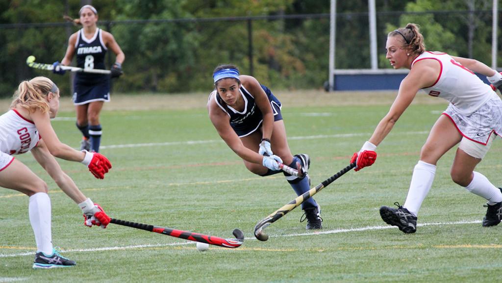 Senior captain Olivia Salindong takes a shot while two SUNY Cortland defenders attempt to block her shot during the field hockey game Sept. 9 at Higgins Stadium. 