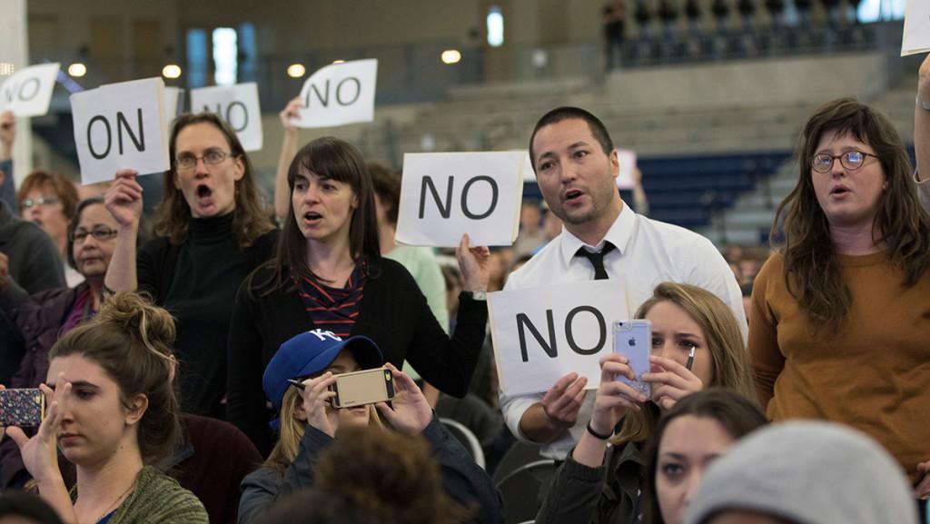 Members of the Ithaca College faculty chant Tom Rochon, no confidence along with students who took stage at the “Addressing Community Action on Racism and Cultural Bias” event in the A&E Center Oct. 27.