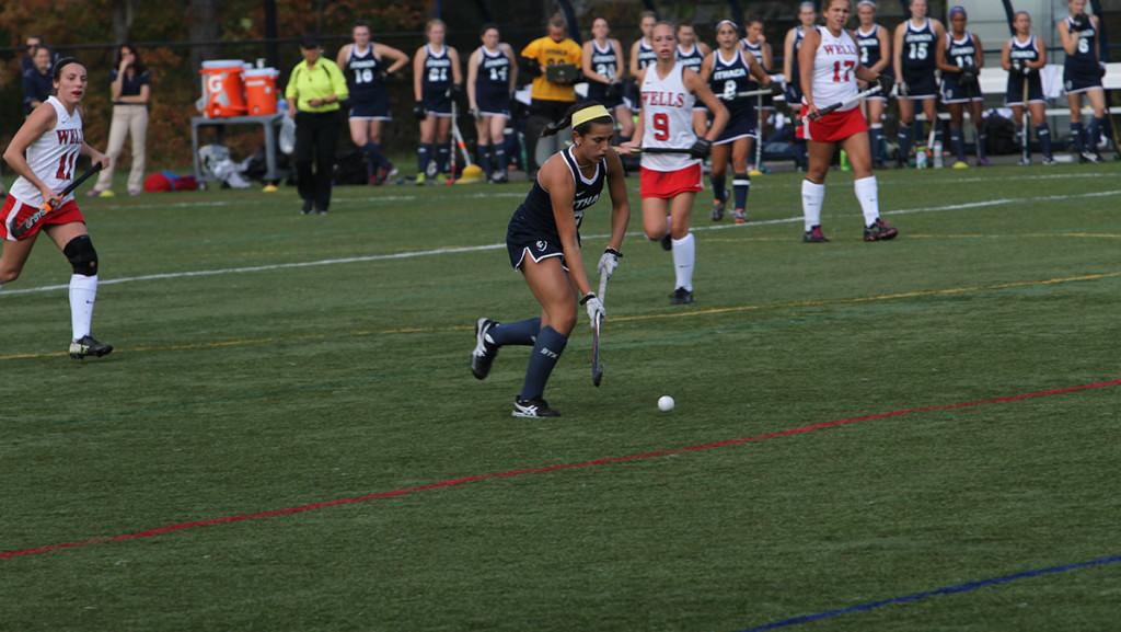 Junior forward Colleen Keegan-Twombly moves the ball up the field during the field hockey teams 7–0 shutout victory over Wells College on Oct. 7 at HIggins Stadium.