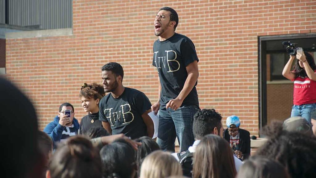Senior Elijah Breton leads chants at a protest Oct. 21 as freshman Marissa Booker and senior Eddy Tapia stand nearby. The two primary chants at the demonstration were “Tom Rochon, no confidence” and “No more dialogue, we want action.”             