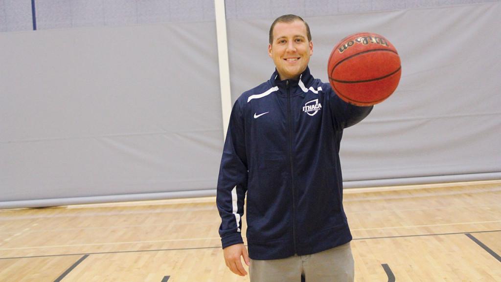 Sean Burton poses in Ben Light Gymnasium with a basketball, as he was hired as assistant mens basketball coach in September. Burton played for the program from 2005-09, and was a two-time All-American and captain for the Bombers. 