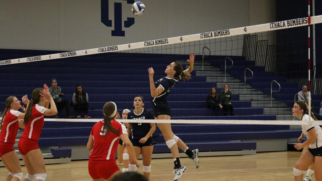 Freshman+Katie+Evans+spikes+the+ball+in+the+volleyball+teams+contest+against+rival+SUNY+Cortland+on+Oct.+7+at+Ben+Light+Gymnasium.