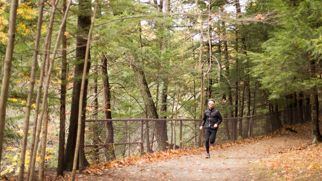 Senior Devin Larsen runs out of the woods on a trail Oct. 25 at Buttermilk Falls. He trained for months to compete in the Trail Animals Running Clubs 100-mile ultra marathon a few weeks ago.