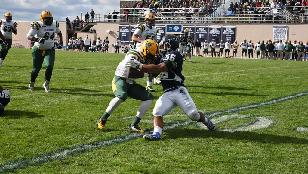 Sophomore linebacker Kenny Bradley tackles SUNY Brockport running back Dan Andrews during the football team’s 27–17 loss to the Golden Eagles on Oct. 17 at Butterfield Stadium.