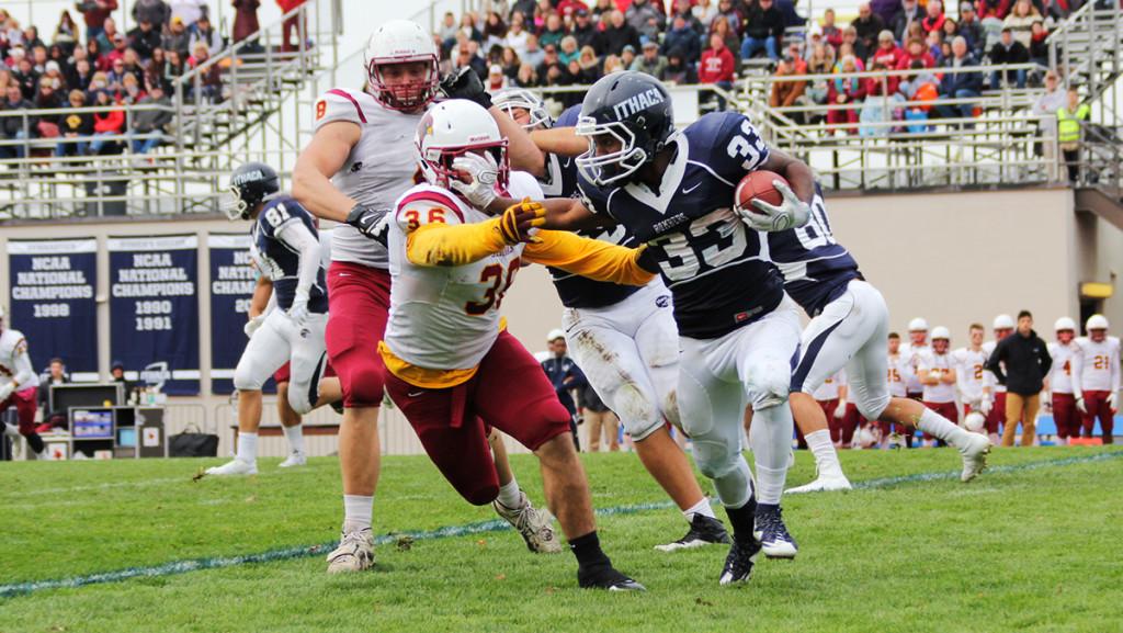 Sophomore running back Tristan Brown stiff arms a St. John Fisher College defense during the football game Oct. 31 at Butterfield Stadium. Brown had nine carries for 23 yards, but the rushing attack totaled just two yards on the day.