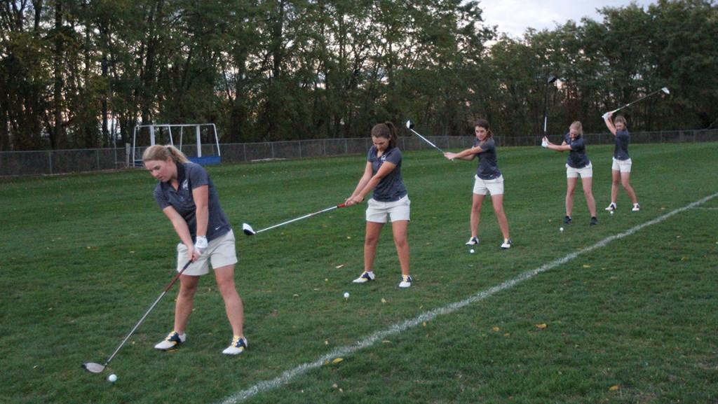 From left to right, senior Mary Rooker, sophomore Kyra Denish, senior Colleen Vaughn and sophomores Indiana Jones and Lauren Saylor practice hitting balls on the practice fields. 