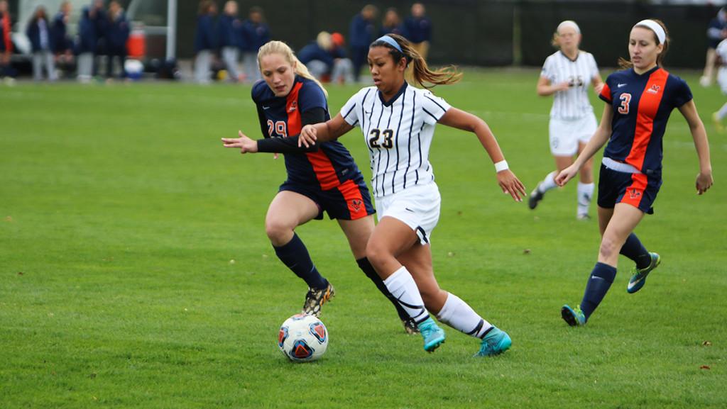 Sophomore+midfielder+Kristyn+Alonzo+dribbles+the+ball+past+a+Utica+College+defender+on+Oct.+31+during+the+womens+soccer+game+at+Carp+Wood+Field.+