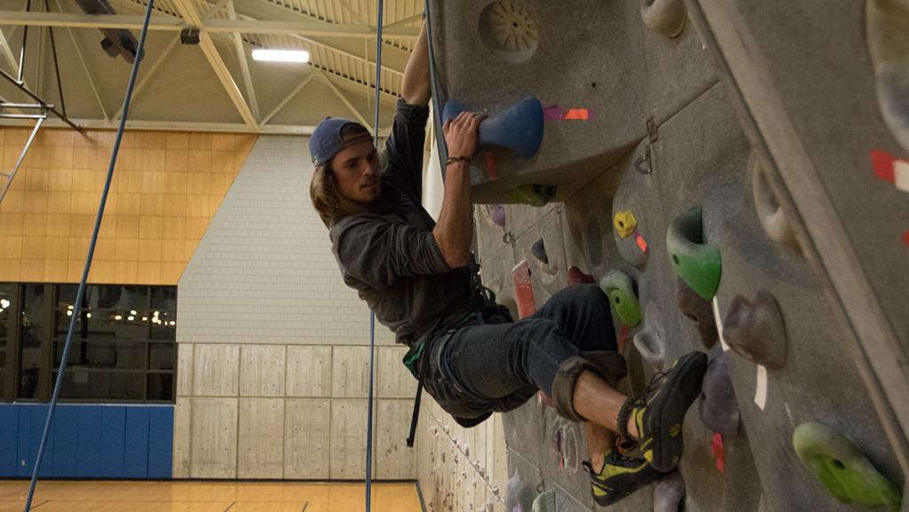 Junior Sean Phillips climbs up the rock wall in the Fitness Center on Nov. 2. He, along with about 10 to 20 students, participate every night. 