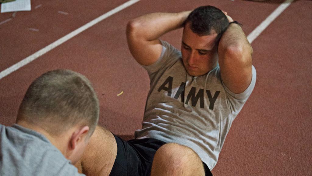 Ithaca College Sophomore Conor Friend does sit-ups as a part of his ROTC training. Friend has an intense schedule, balancing both ROTC training and a full course load. 