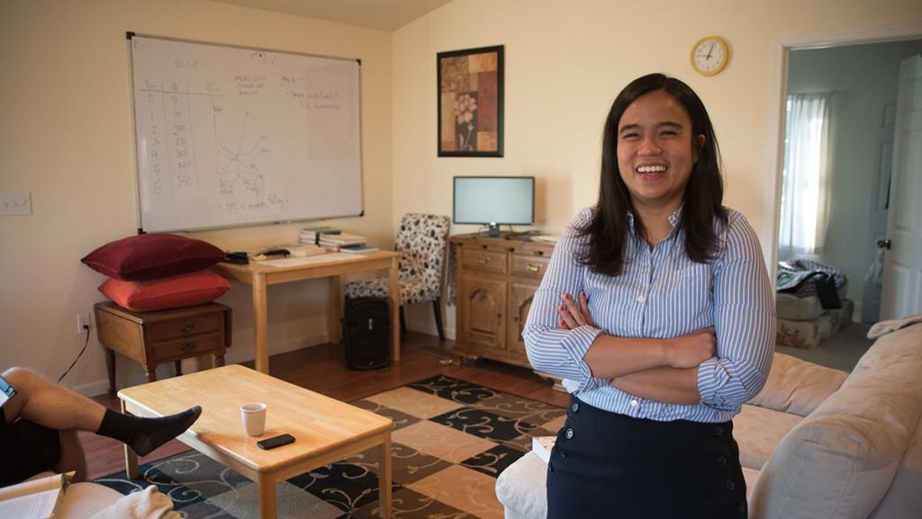 Puspa Amri, assistant professor for the Department of Economics, stands in the living room of her home in Ithaca. Amri said she advertised herself to renters online before she moved from California. 