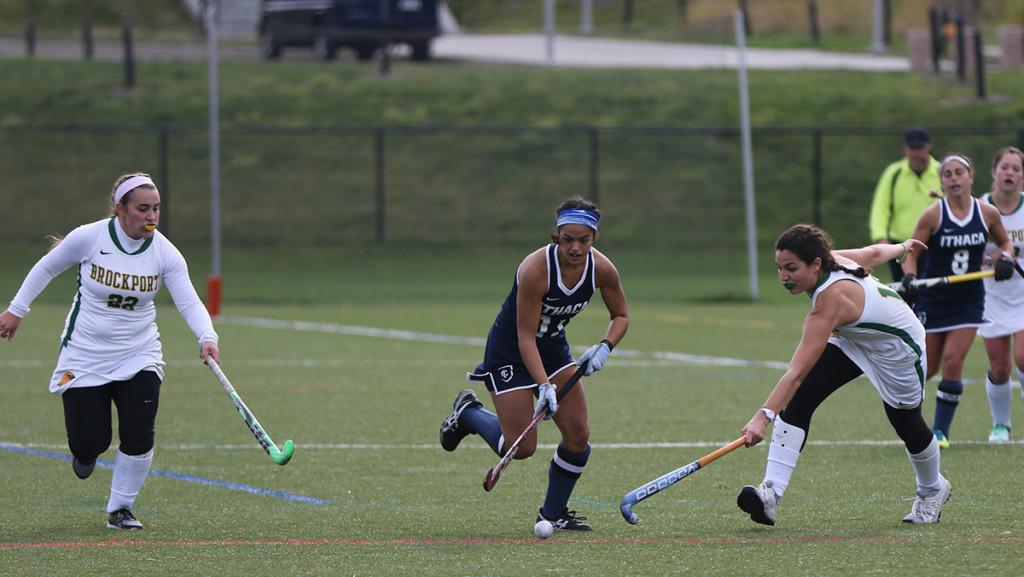 Senior midfielder Olivia Salindong dribbles past two SUNY Brockport defenders during the field hockey game Oct. 31 at Higgins Stadium. Salindong tallied an assist in the 5–0 win against the Golden Eagles.