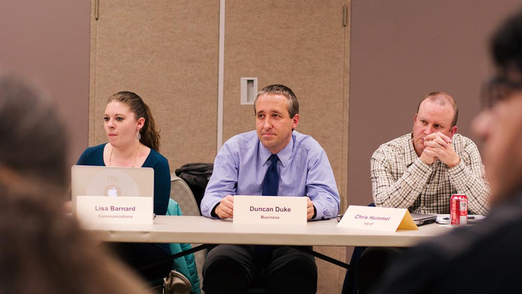 From left, Lisa Barnard, assistant professor in the strategic communication department; Duncan Duke, assistant professor in the management department; and Chris Hummel, associate professor in the exercise and sports science department, listen to the discussion at the Dec. 1 Faculty Council meeting. 