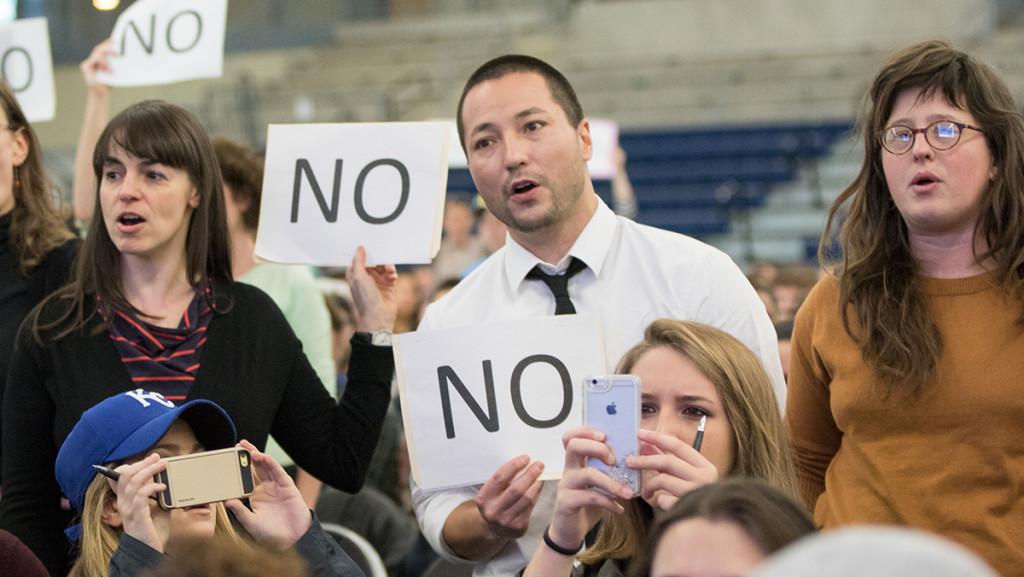 Members of the Ithaca College faculty hold up No signs at the Oct. 27 Addressing Community Action on Racism and Cultural Bias event in the Athletics and Events Center. Faculty share their responses to Rochons announcement that he will be retiring at the end of the 2016-17 school year.