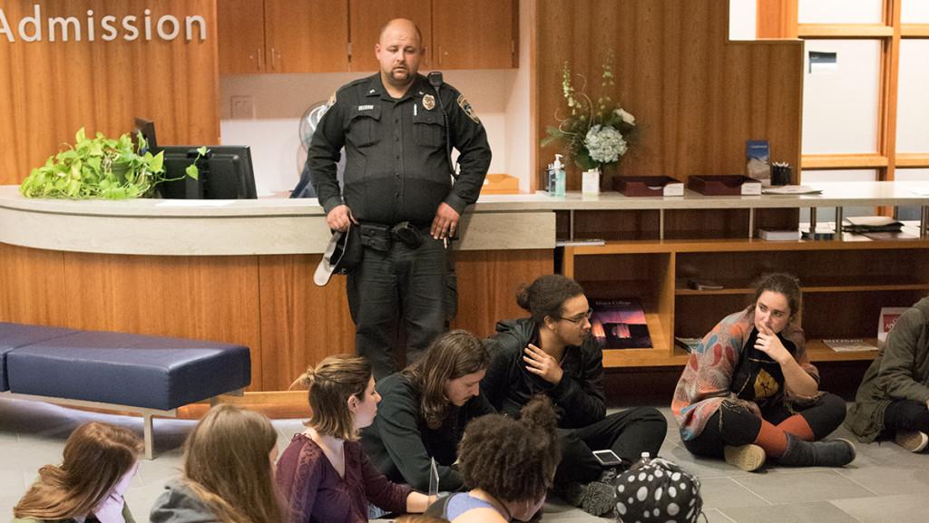 A public safety officer oversees a group of students occupying Peggy Ryan Williams Center Dec. 8.