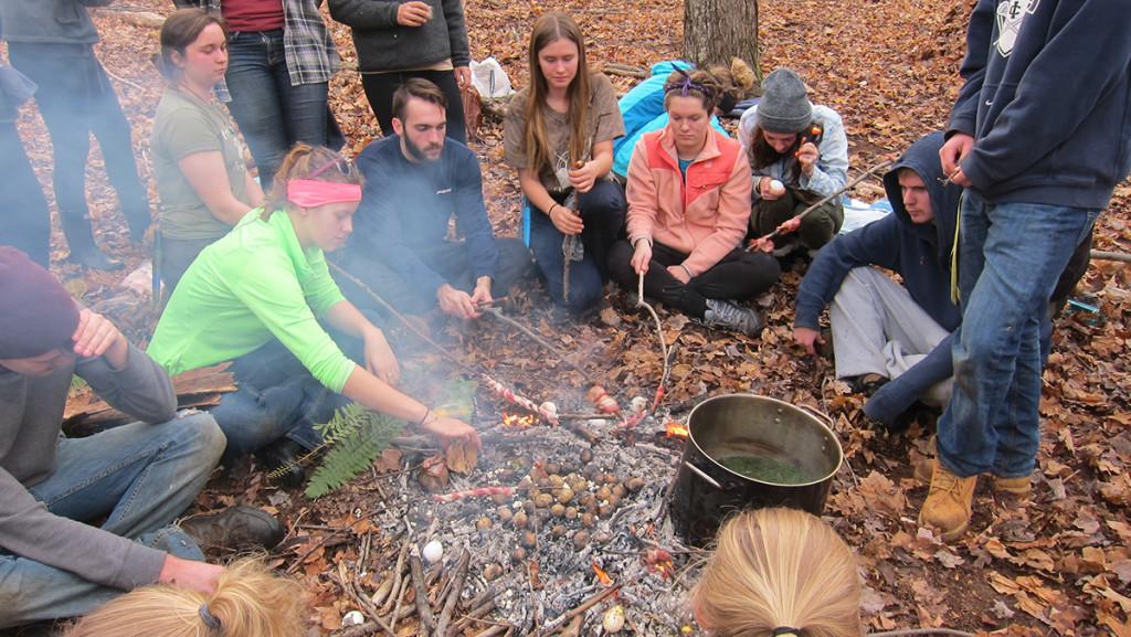 Students cook food over a campfire as a part of Environmental Sentinels, a class in the environmental studies department. An updated environmental studies minor will be available in the course catalog for the Fall 2016 semester.