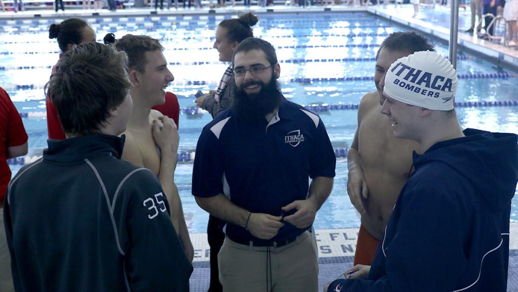 Assistant coach Lucas Zelehowsky is surrounded by several Bomber swimmers Dec. 5, 2015 at the Bomber Invitational. Zelehowsky was hired as the mens swimming and diving  assistant coach this season.