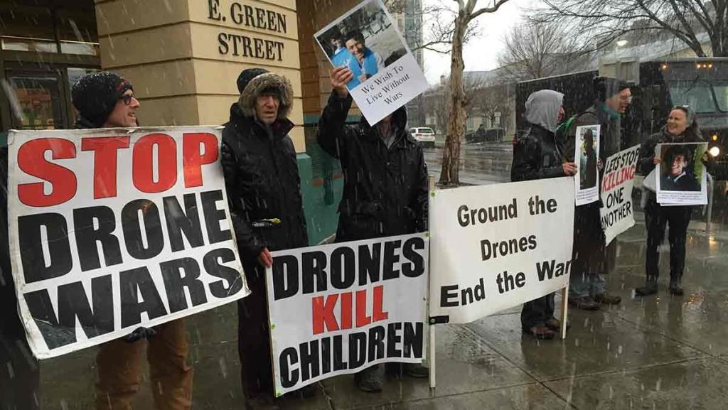 Members of Ithacas Catholic Workers protest in front of Tompkins County Public Library against the use of drones. 