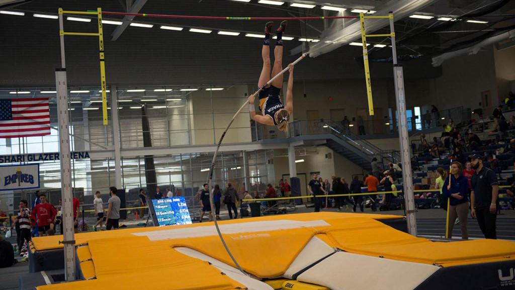 Junior Katherine Pitman ascends over the bar during the New York State Collegiate Track Conference Championships on Feb. 26 in Glazer Arena. Pitman broke her own school record in pole vault with a height of 4.07 meters.
