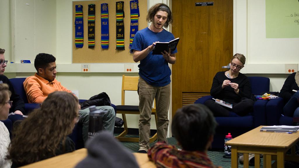 During a Spit That! meeting, member Robert Amoils reads a poem. On Feb. 6, the group will square off against Cornell in a poetry slam.