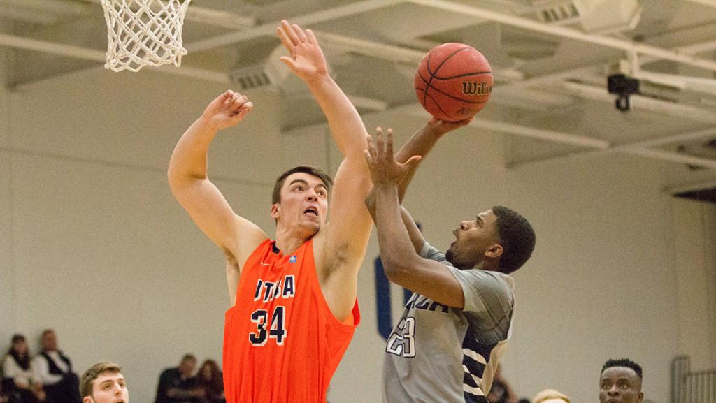 Sophomore guard Carroll Rich attempts a shot Feb. 19 against Utica College. The Bombers lost 84–75.