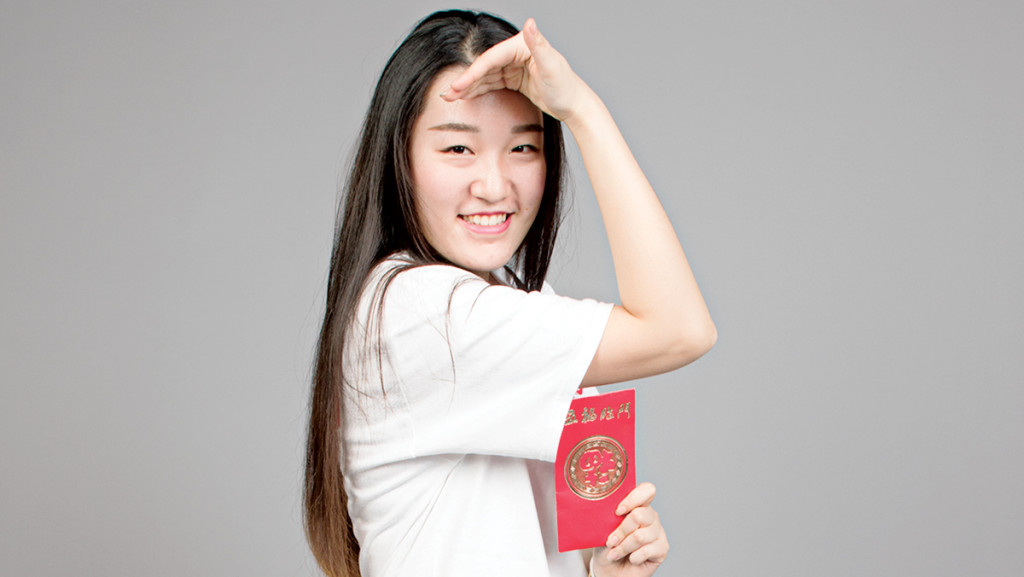 Junior Xuan Gui strikes a monkey pose to commemorate the Year of the Monkey for Chinese New Year. She also holds a red envelope to represent good luck and warding off evil spirits.