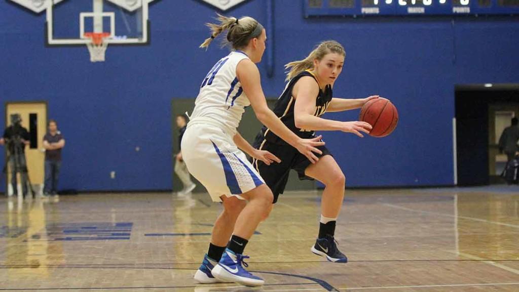Sophomore guard Erin Woop drives past a defender Feb. 20 against Hartwick College. The Bombers clinched a spot in the Empire 8 Tournament with a 78–61 victory over the Hawks.