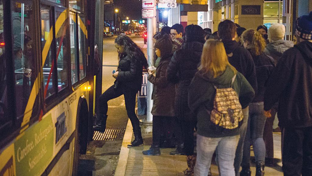 Students board an outbound Route 11 TCAT bus at the Seneca Street Station the night of Feb. 6. Nancy Oltz, TCAT operations manager, said the company often brings on additional buses at peak times on Friday and Saturday nights to accomodate large amounts of student riders. 