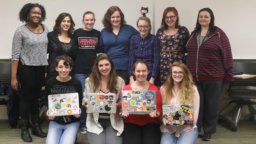 Members of IC Women in Computing show off some of the prizes they won from the hackathon event. 
