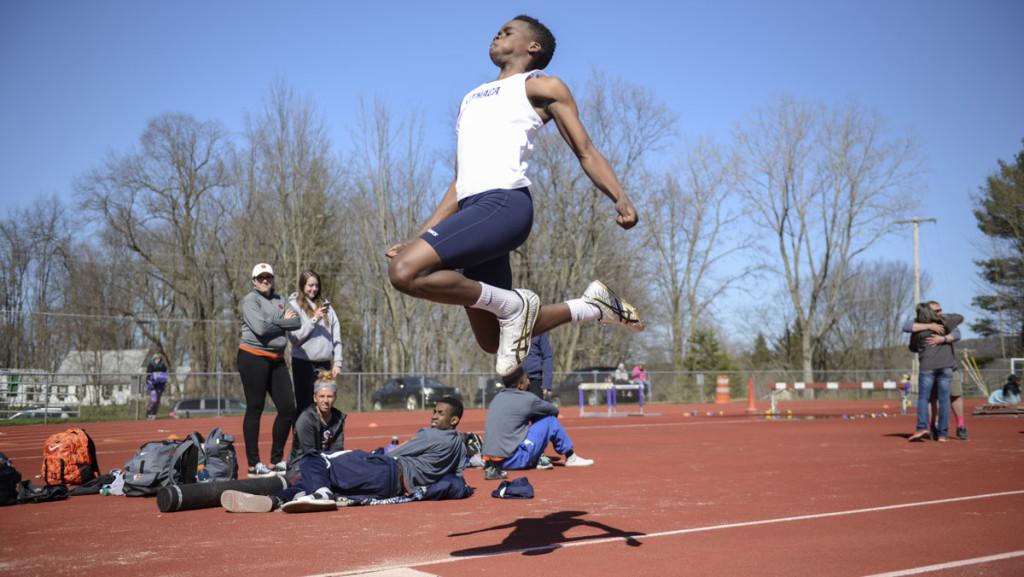 Freshman Alex Arika competes in the triple jump April 23 at the Empire 8 Championship. He placed third with a jump of 12.9 meters.