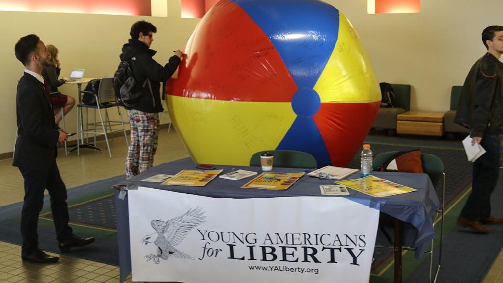 Students write messages in Sharpie across a giant beach ball inside the Campus Center on April 11. The beach ball was a part of Freedom Week, an event put on by IC Young Americans for Liberty to advocate for free speech.