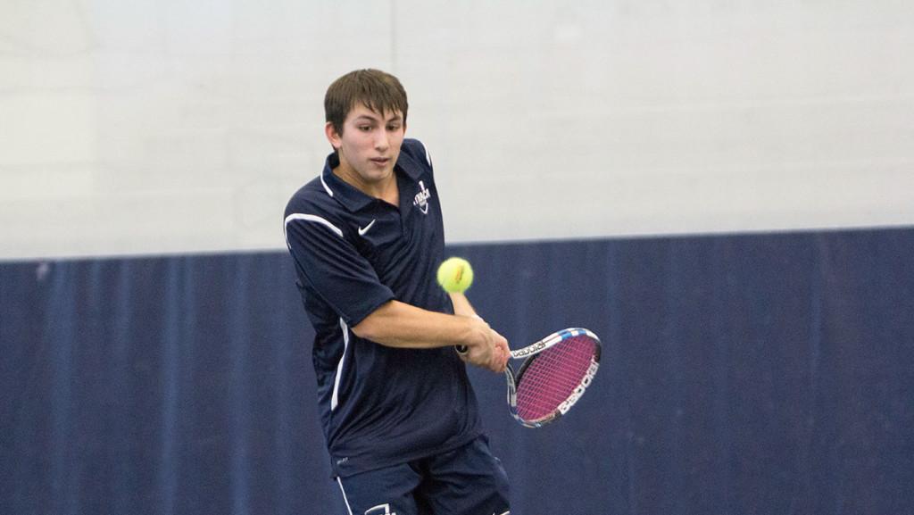 Senior Chris Hayes goes to return the ball during a match February 24 against the University of Rochester.