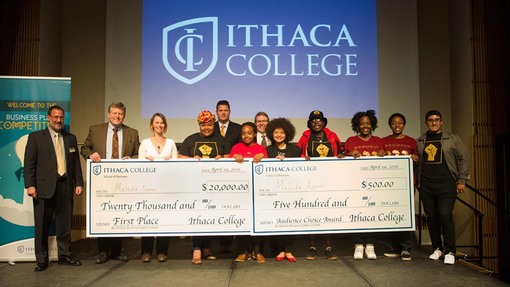 Senior Rita Bunatal, fourth from left, accepts the $20,000 first-place prize in the Business Plan Competition on behalf of her company, Malaika Apparel.