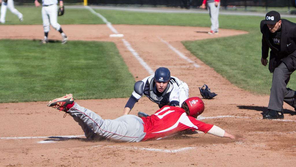 Junior catcher Ryan Henchey goes to tag senior Connor Griffin at home plate in the Bombers game against SUNY Cortland April 14.