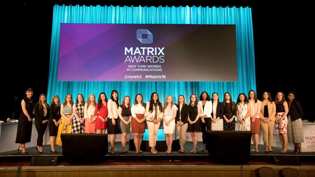 The 22 NYWICI scholarship winners, including the six Ithaca College women, pose on stage at the 2016 Matrix Awards on April 25 in New York City. 