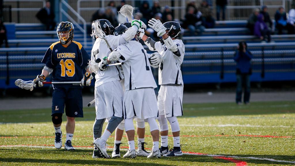 The+mens+lacrosse+team+celebrates+during+its+game+against+Lycoming+College+on+March+1+in+Higgins+Stadium.