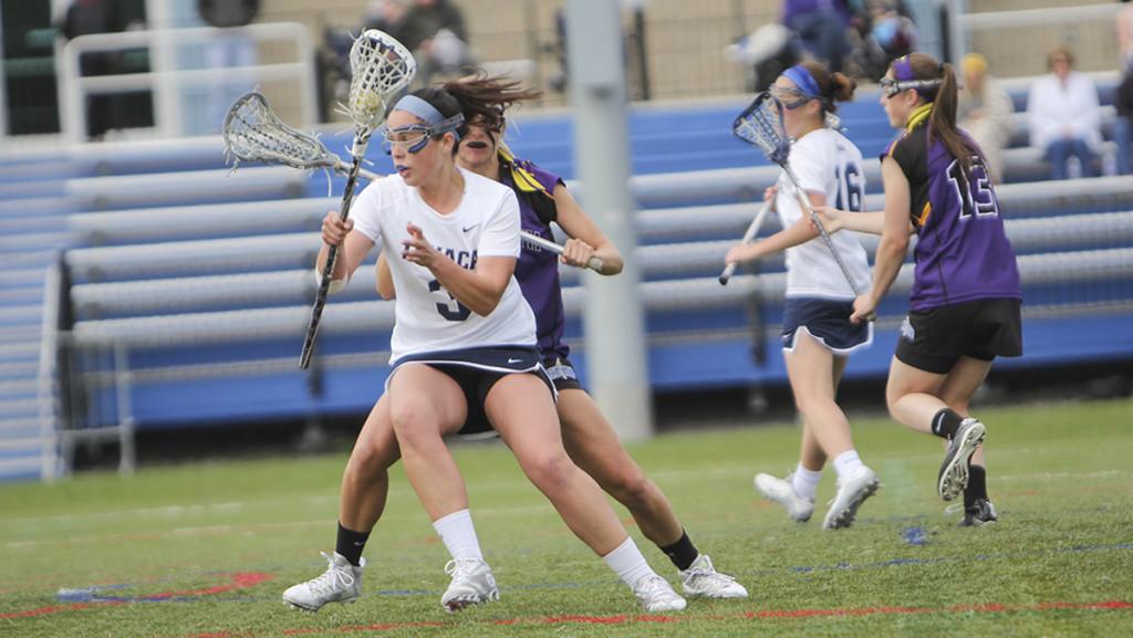 Junior attackman Morgan Racicot avoids a Nazareth College defender May 7 in Higgins Stadium. She scored two goals and had one assist. 