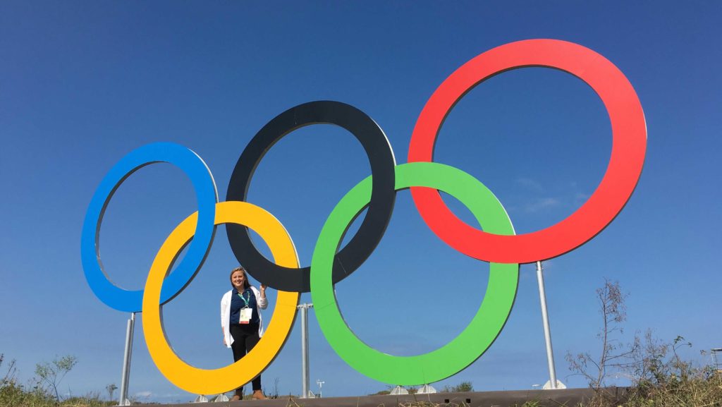 Overholt stands in front of the Olympic rings in Rio De Janeiro. She missed part of the tennis preseason because she was interning for NBC Olympics in Rio de Janeiro, where she was a runner at the Olympic Golf Course.