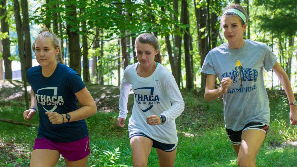 Junior Georgia Caplen and sophomores Emilie Mertz and Julie Rand practice in the nature lands behind upper terraces Aug. 19 in preparation for the upcoming season. 