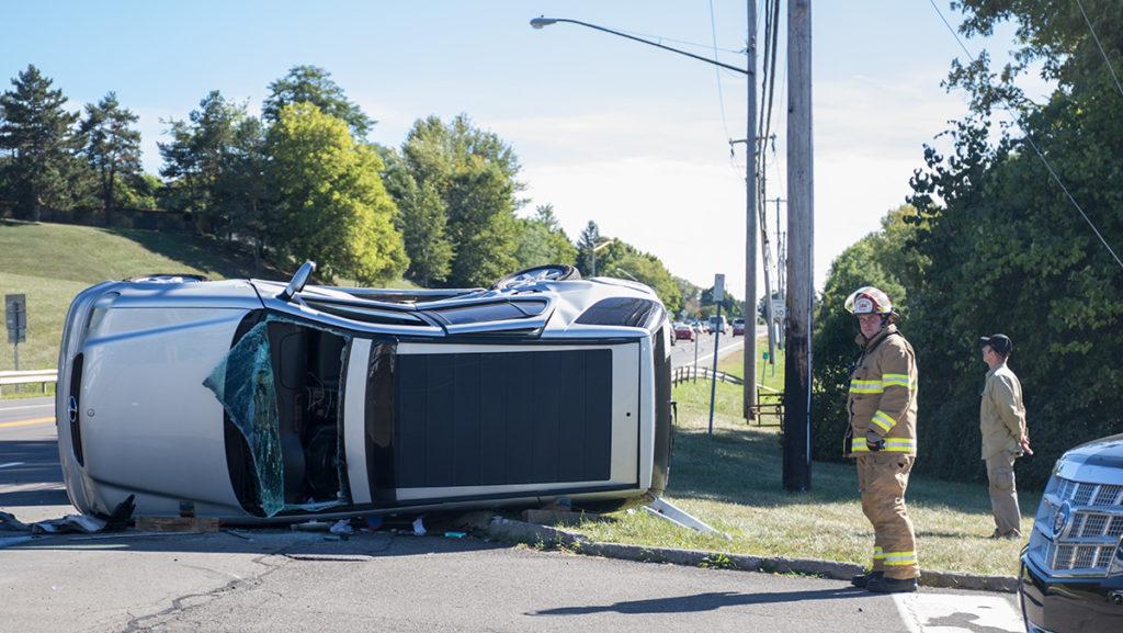 Two cars crashed at the intersection of Alumni Street and Danby Road, across from the main entrance to Ithaca College. One person involved was a student at the college, who was driving a a silver Mercedes SUV that overturned in the crash. 