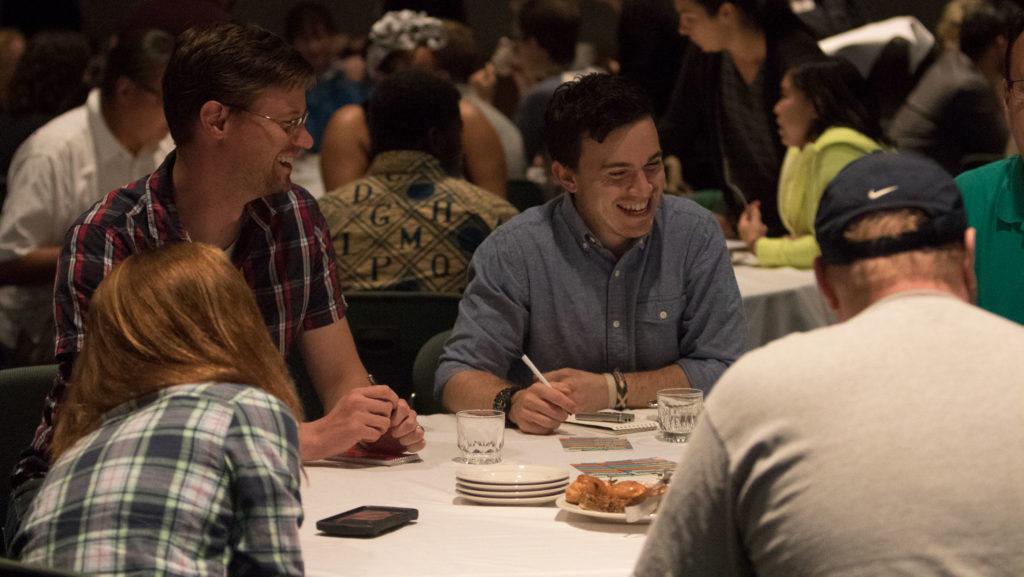 From left to right, Stephen Shoemaker and Dan Verdosa, who both work in the Office of Strategic Marketing and Communications, talked and laughed with people at their table at the Community Gathering event held Aug. 31.
