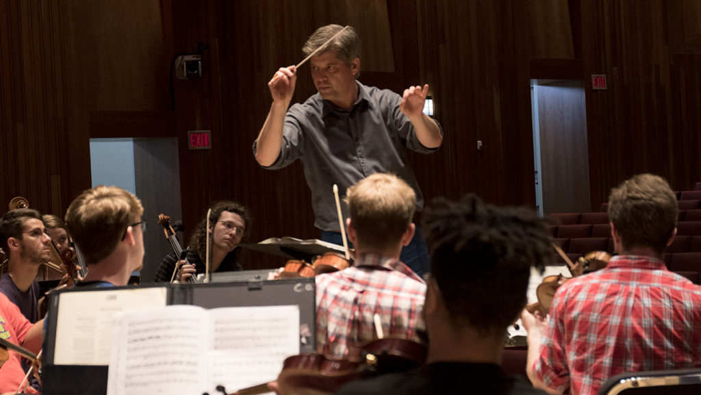 Michael Hall, assistant professor in the Department of Music Performance, leads the Chamber Orchestra during a rehearsal Sept. 7 in the James J. Whalen Center for Music.