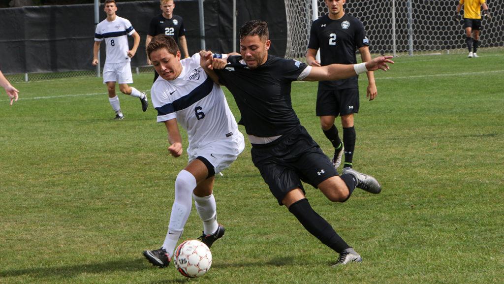 Sophomore Zach Lichtman in a one-on-one against a Stevens Institute of Technology defender Sept. 18 at Carp Wood Field. The Bombers beat the Ducks 1–0.