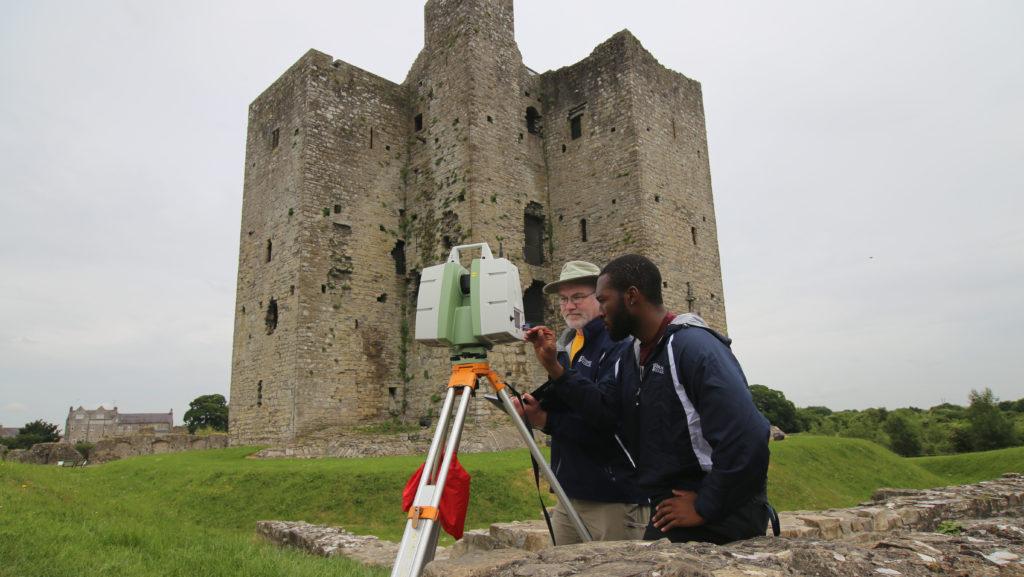 Michael Rogers, a professor in the Department of Physics and Astronomy, and sophomore Chidi Anyata, work with a 3-D scanner outside of Trim Castle in Trim, Ireland. Over this past summer, a team of six Ithaca College students and professors produced a 3-D scan of Trim Castle and its surrounding historical structures.