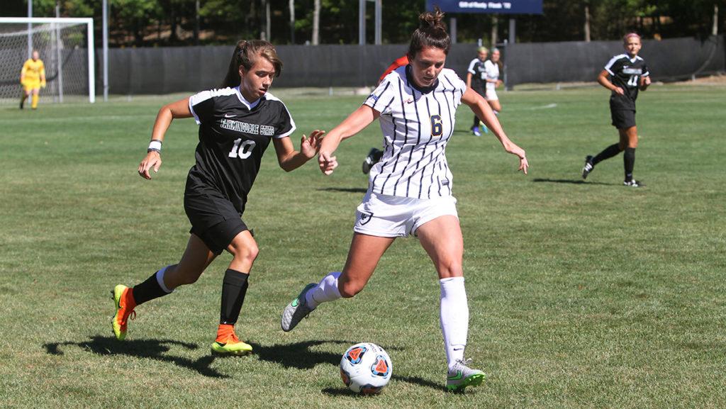 Sophomore forward Sam Robinson dribbles away from a SUNY Farmingdale defender Sept. 11. The womens soccer team will host the Upstate Collegiate Cup Sept. 17–18 at Carp Wood Field.