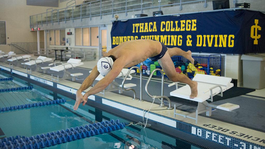 Senior Adam Zelehowsky dives into the pool during practice Oct. 11 in the Athletics and Events Center. FERNANDO FERRAZ/THE ITHACAN