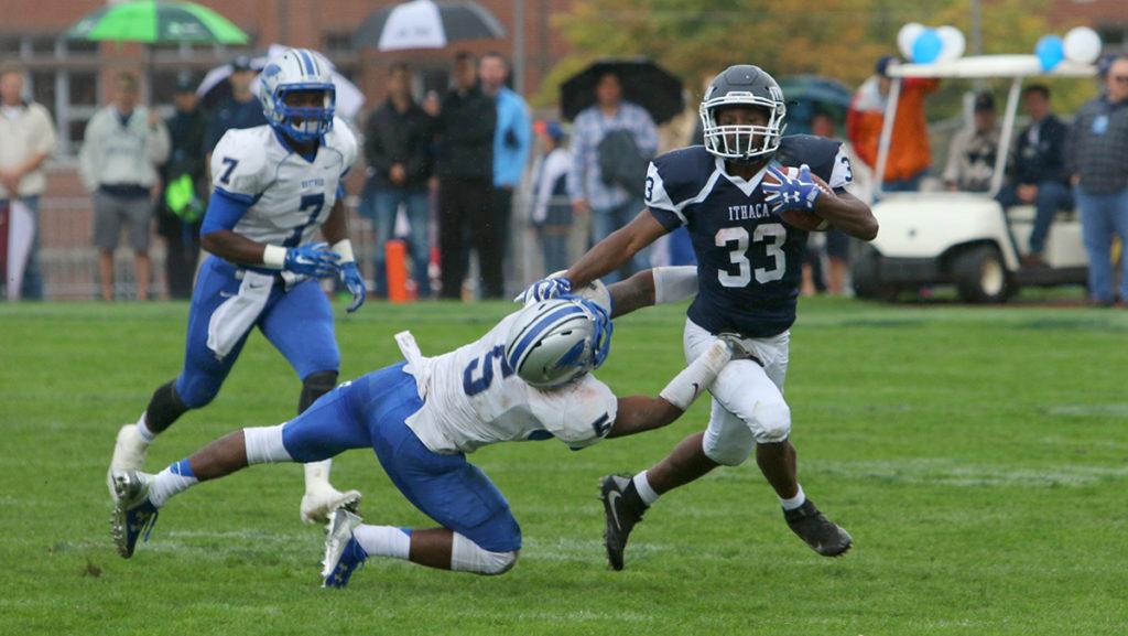 Junior running back Tristan Brown avoids a tackle from Hartwick College junior Eugene Allen III Oct. 8 at Butterfield Stadium. Brown scored two touchdowns to help the Bombers defeat the Hawks 50–27.  