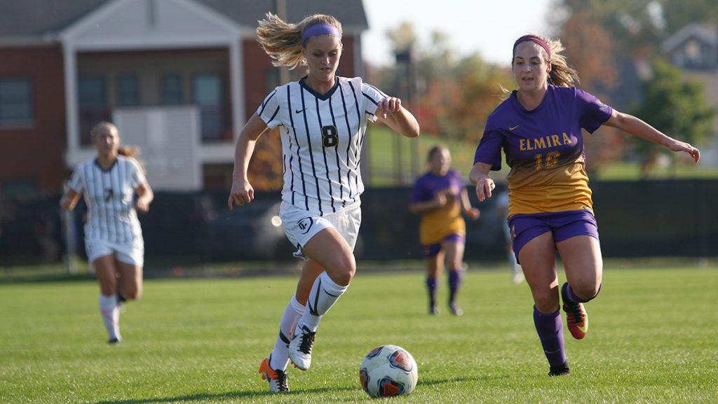 Senior Cate Douglass beats Elmira College junior Sara Kazerouni to the ball in the Bombers game Oct. 18. The Bombers defeated the Soaring Eagles 8–1.